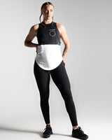 Women's two-panel sleeveless shirt, black on top and white at the bottom, made with tri-blend fabric for performance and sweat-wicking.