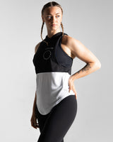 Left side view of Women’s sleeveless hoodie with two-tone black and white panels, made from performance fabric. 