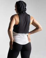 Back view of Women’s sleeveless hoodie with two-tone black and white panels. 