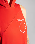 Detailed view of the white Lyftlyfe logo and circle star on a red women's sleeveless hoodie. 