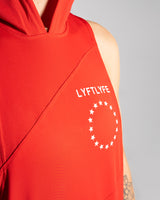 Detailed view of the white Lyftlyfe logo and circle star on a red women's sleeveless hoodie. 