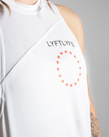 Detailed view of the LYFTLYFE logo and circle start on a white women's sleeveless tank top. 