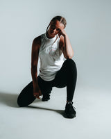 Women’s sleeveless shirt featuring three panels in white, sweat-wicking fabric, and Lyftlyfe logo with a circle star on the chest.