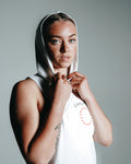 Close-up view of Women’s athletic hooded tank top in white. 