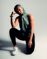 Women’s sleeveless gym tank top in green, highlighting its lightweight mesh panels and moisture-wicking properties.