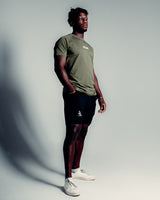 Side view of green Contour Men’s T-Shirt,  showing its fitted cut, wrinkle-resistant fabric, and smooth stitching details.