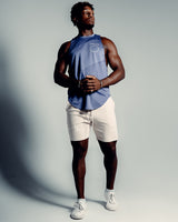 Men’s sleeveless tank in blue, featuring a scoop hem, performance stretch fabric and a white LYFTLYFE logo.