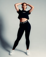 Perfectly cropped Drill Women’s Tee in black, featuring a soft crew neckline and breathable moisture-wicking cotton blend.