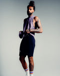 Men’s sleeveless tank top in purple, shown from the side, highlighting lightweight, wrinkle-resistant performance fabric. 
