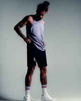 Men’s sleeveless gym tank in purple, shown from the side, highlighting moisture-wicking fabric for breathability.