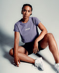 Women’s cropped Drill Tee in purple, featuring a soft crew neckline and premium cover-stitching.