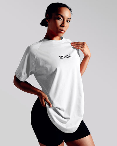 White LYFTLYFE contour t-shirt with black logo on light grey. 