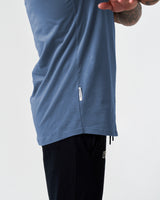 Detailed view of the LYFTLYFE side flag tag on the blue Contour Tee, adding a signature touch to the fitted men’s t-shirt.