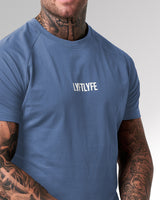 Close-up of the 3D rubberized LYFTLYFE logo on the chest of the Contour Men’s T-Shirt in blue, adding a premium touch.