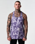 Model wearing sweat-wicking purple gym stringer tank front view.