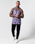 Full body shot of model in purple haze gym stringer and black joggers. 
