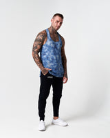 Athlete wearing LYFTLYFE’s blue sponge print gym stringer full-body.