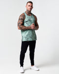 Head-to-toe shot of model wearing green marble gym tank.