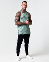 Head-to-toe shot of model wearing green marble gym tank.