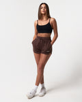 Women’s high-waisted dark brown Balance Shorts featuring an elasticized waistband, drawstring, and side pockets.