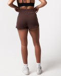 Back view of women’s Balance Shorts in dark brown, featuring a relaxed fit, elastic waistband, and plush fabric.