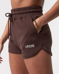 Close-up of women’s Balance Shorts in dark brown, featuring the Lyftlyfe logo, elasticized waistband, and tonal drawstring.