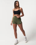 Stylish green women’s shorts with ultra-plush material, elastic waistband, and a modern high-waisted design.