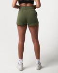 Back profile of women’s lightweight green sweat shorts with tonal stitching and premium cotton-polyester blend.