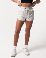 Light grey women’s shorts with ultra-plush material, elastic waistband, and a modern high-waisted design.