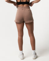Women’s taupe Balance Shorts shown from the back, highlighting durable shape-retaining fabric and modern design.