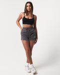 Women’s Balance Shorts in dark grey, highlighting side pockets, high-waisted fit, and a white LYFTLYFE logo on the left side. 