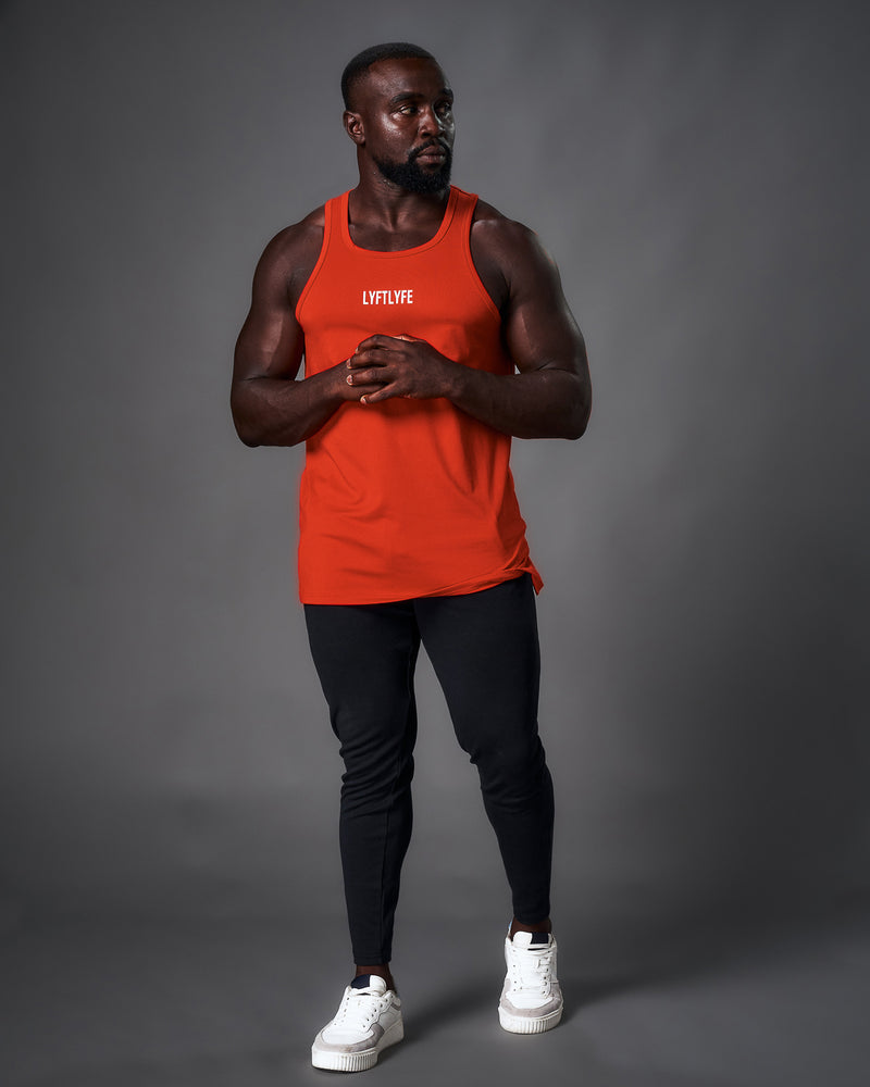 Mens tank top in a red molten color. White logo in the middle of chest.