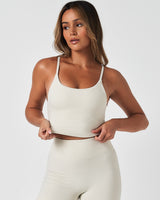 White women’s athletic tank with built-in bra and high neck, offering breathable, moisture-wicking comfort.