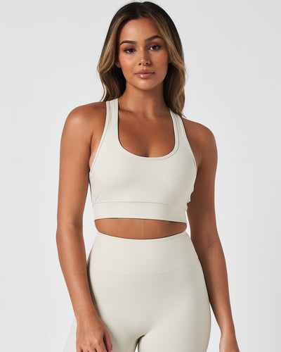 Front view of the Force Bra in Vapor White, featuring a scoop neckline and minimalist design for medium support.