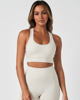 Front view of the Force Bra in Vapor White, featuring a scoop neckline and minimalist design for medium support.