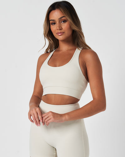 Front view of the Force Bra in Vapor White, featuring a scoop neckline and minimalist design for medium support.