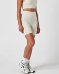 Right side view of women’s Force 6.5" biker shorts in vapor white, featuring a seamless waistband and sculpting fit.