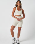 Full body shot of woman in LYFTLYFE Force shorts and bra set in vapor white, styled for high-performance workouts.