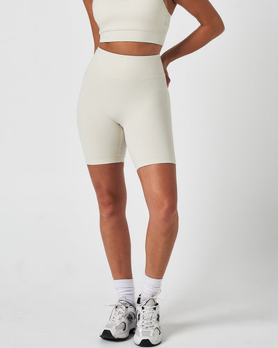Front view of women’s Force 6.5" biker shorts in vapor white, featuring a seamless waistband and sculpting fit.
