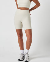 Left side view of women’s Force 6.5" biker shorts in vapor white, featuring a seamless waistband and sculpting fit.