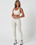 Full body shot of model in Force leggings and matching top in Vapor White, highlighting full fit.