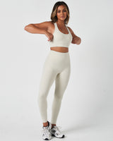 Complete activewear outfit showing the Force Bra with 4-way stretch leggings in a coordinated neutral tone.