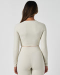 Rear view of Force Long Sleeve Crop in white, highlighting sculpted seams and clean athletic cut.