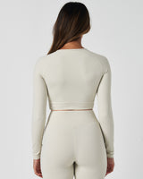 Rear view of Force Long Sleeve Crop in white, highlighting sculpted seams and clean athletic cut.