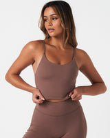 Front view of Force Tank in brown, featuring high neckline, skinny straps, and sculpting fit with built-in bra.