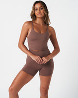 Athletic outfit featuring brown Force Tank and shorts, built for performance and sculpted silhouette.