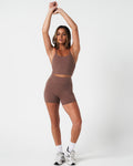 Complete look of women’s workout tank in brown, styled for comfort, shape, and stretch.
