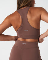 Close-up of back waistband on LYFTLYFE Force 4'' shorts in brown with reflective LYFTLYFE logo detail.