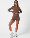 Full body view of women’s Force Long Sleeve Crop paired with matching brown shorts.