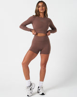 Full body view of women’s Force Long Sleeve Crop paired with matching brown shorts.